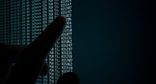 a finger pointing at a computer screen displaying the data from a geforce gtx 750 graphics card