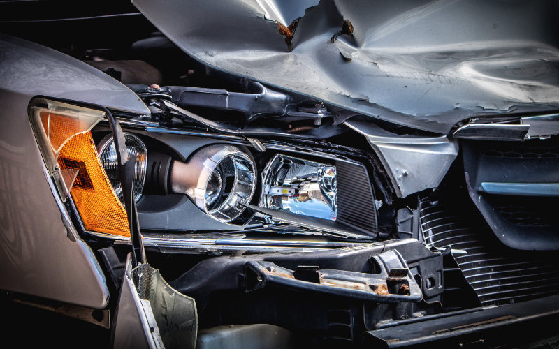 a closeup view of a car with broken headlights which is caused by a crash