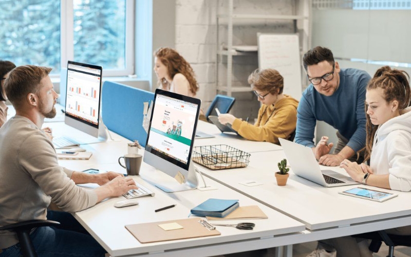 a collaborative workspace with multiple people working on computers