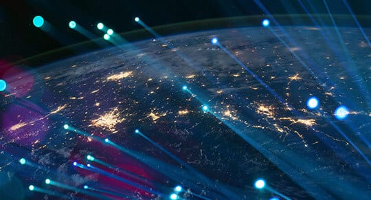 a top view of earth illuminated with blue lights and city lights at night